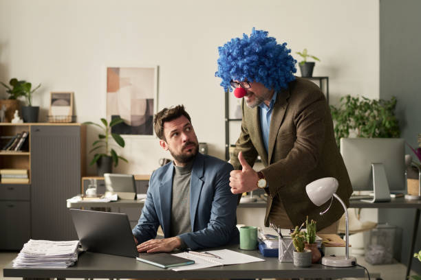 istock Clown boss commending male subordinate 2195835690