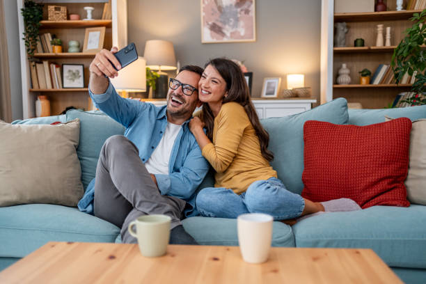 istock Young couple taking selfies at home 2195835791