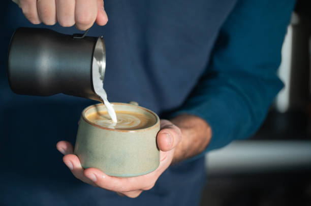 istock Pouring steamed milk into cup for latte art 2195836026