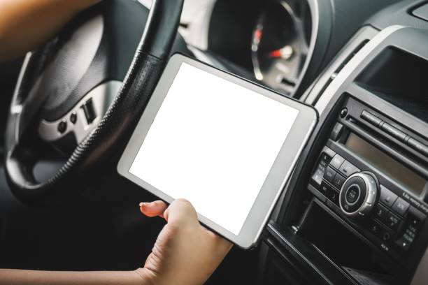 istock Woman holding a tablet while driving 2195838306