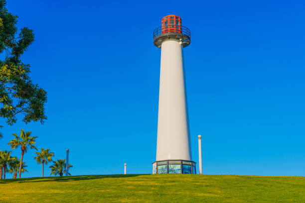 Long Beach, California - January 15, 2025: Lions Lighthouse prominently displayed on a grassy hill under a clear blue sky at Shoreline Marina, Long Beach.