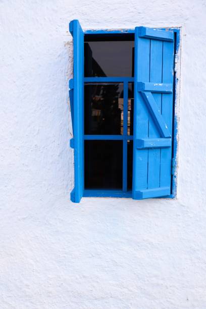 istock An enchanting blue window set against a pristine white wall creates a visually captivating scene 2195842780