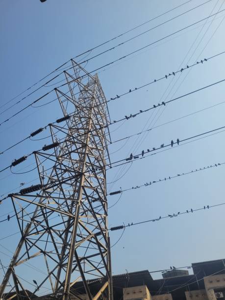 istock Tall electricity pylon against blue sky on sunny day 2195842809