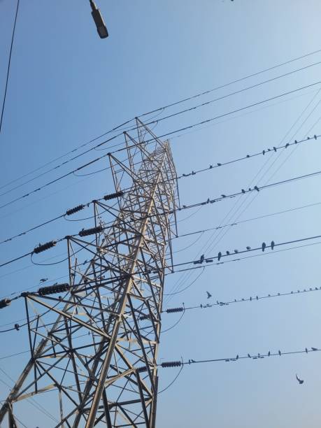 istock Tall electricity pylon against blue sky on sunny day 2195842812