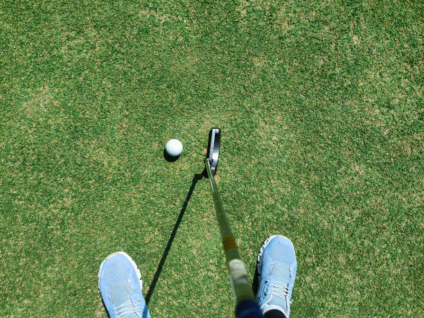 istock POV Golfer Ready To Strike Golf Ball on the grass field 2195843021