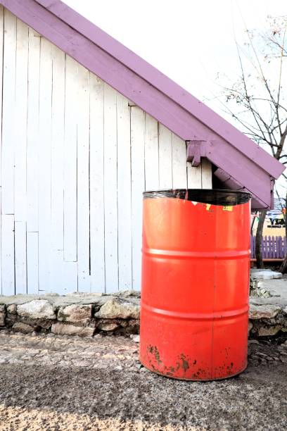 istock A rustic red barrel sits next to a charming white building, adding character to the scene 2195843097