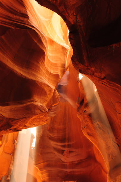A mesmerizing play of light and shadow illuminates the smooth, undulating sandstone walls of Antelope Canyon. The surreal textures and deep hues of blue, purple, and orange create a stunning abstract composition, shaped by millennia of erosion. This fine art photography captures the mystical essence of the Southwest’s geological wonders, offering a unique perspective on nature’s artwork.