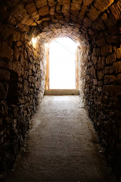 istock An enchanting stone tunnel that leads out to a bright and illuminating light beyond 2195843692