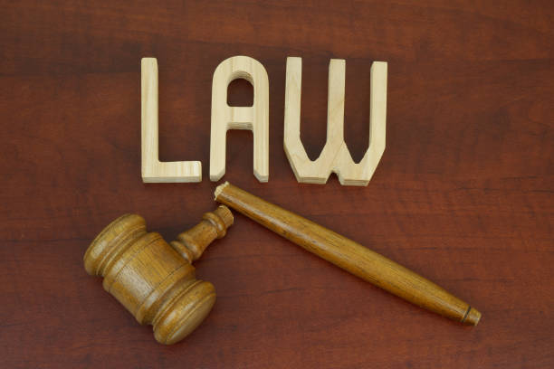 istock Broken judge gavel and letters LAW on table. 2195844068