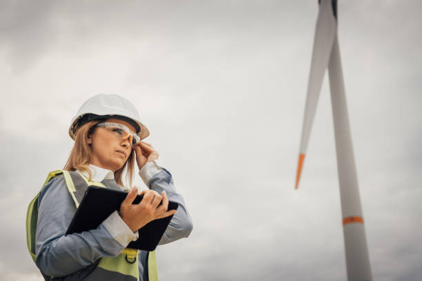 istock A dedicated and skilled professional woman engineer is currently at the wind turbine project site, actively evaluating the overall progress and development of the ongoing project initiatives 2195844764
