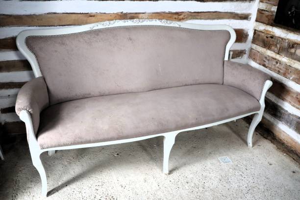 This stylish vintage settee features soft upholstery and is ideal for enhancing classic interiors beautifully