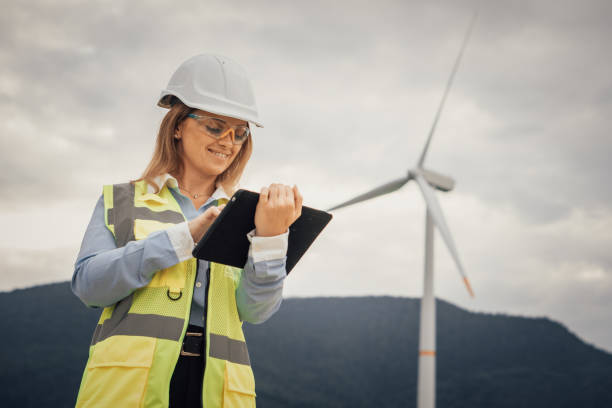 istock A skilled female engineer is meticulously inspecting the efficiency of a wind turbine while utilizing a digital tablet in the diverse and rapidly advancing field of renewable energy solutions 2195844856