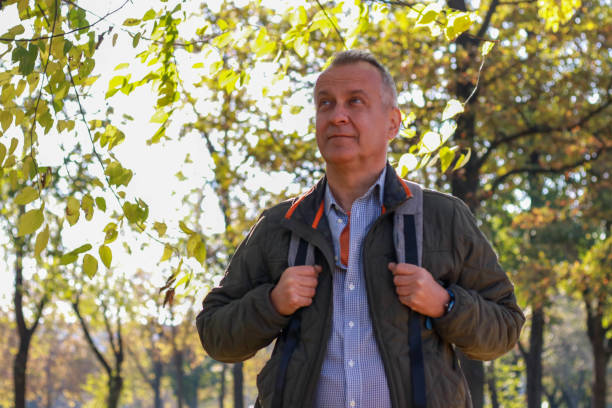 istock Senior businessman hiking and working online 2195844969