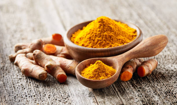 istock Turmeric roots with curry on wooden background 2195845683