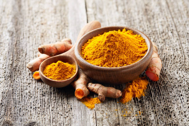 istock Turmeric roots with curry on wooden background 2195845736