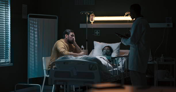 Woman in hospital bed with man beside her, African doctor holding papers Woman in hospital bed with man beside her, African doctor holding papers. night hospital bed stock pictures, royalty-free photos & images
