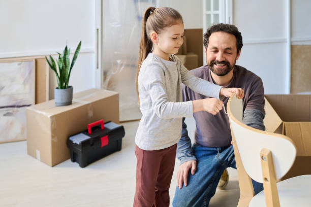 istock Father and daughter fixing chair part 2195847531