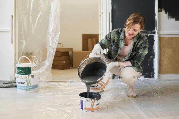 istock Pouring grey paint in plastic bucket 2195847588
