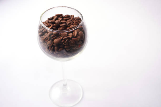 istock Coffee beans in a wine glass against a white background 2195848312