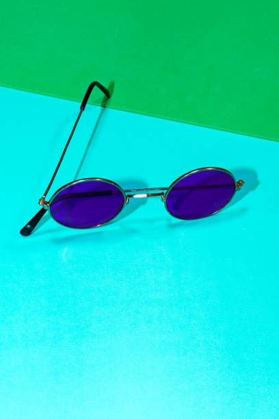 istock Purple round sunglasses on a blue and green background 2195850642