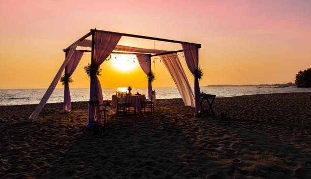 istock The sunset view scene with romantic dinner set up on the beach 2195851380
