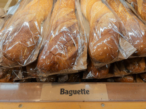 istock Freshly Baked Baguettes Displayed in Bakery Case 2195857830