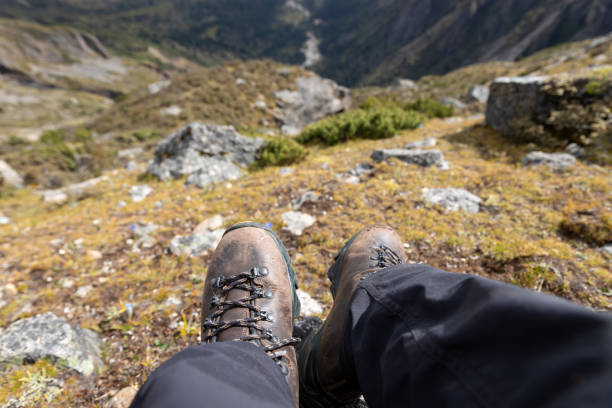 istock Hiker wearing leather hiking boots sit on high altitude mountain top 2195858955