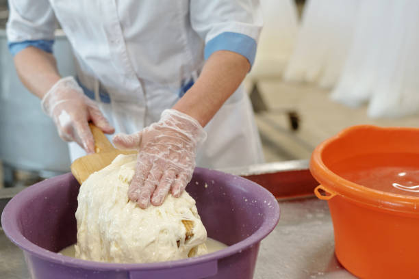 istock Mixing Dough with Hands Wearing Protective Gloves 2195859410