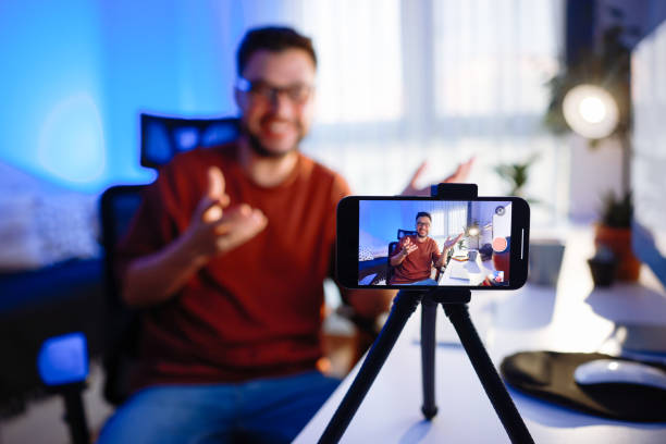 istock Smiling young male influencer doing a vlog post at home 2195869290