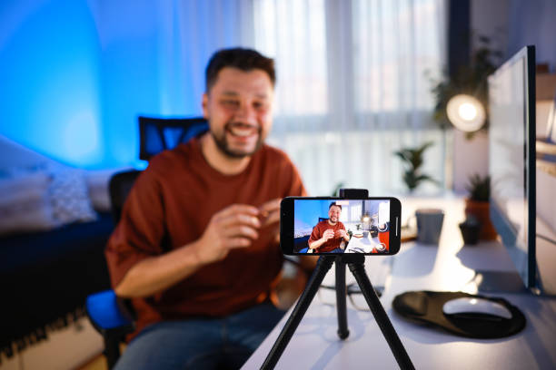 istock Smiling young male influencer doing a vlog post at home 2195869560