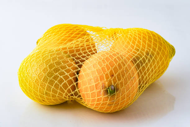 istock Fresh lemons isolated in net ready for sale 2195869629