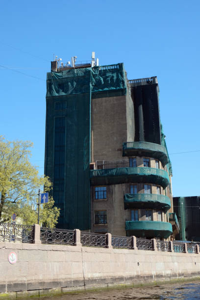 istock A dilapidated Art Nouveau building (formerly a church) covered with construction netting against a blue sky in St. Petersburg 2195872608