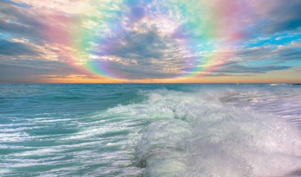 istock Amazing rainbow over the strong sea wave at amazing sunset 2195873081