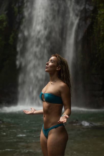 istock Woman in front of a waterfall 2195873264
