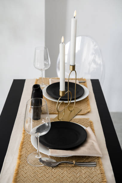 istock Elegant dining table setup with minimalist decor and candles in a modern space 2195875766