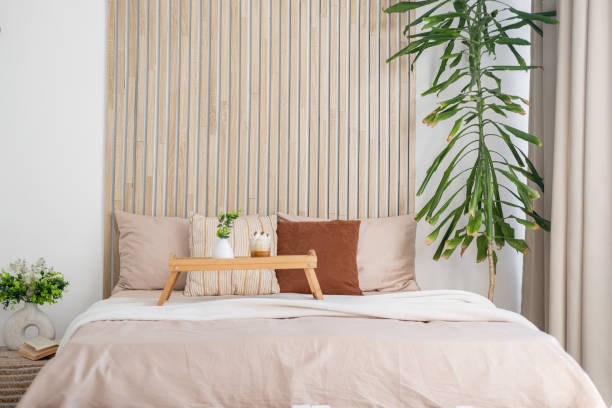 istock Cozy bedroom with wooden accent wall and breakfast in bed setting 2195875777