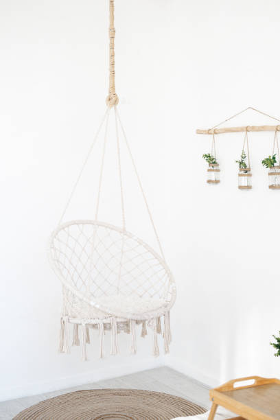 istock Hanging macrame chair adding bohemian charm to a minimalist room 2195875799