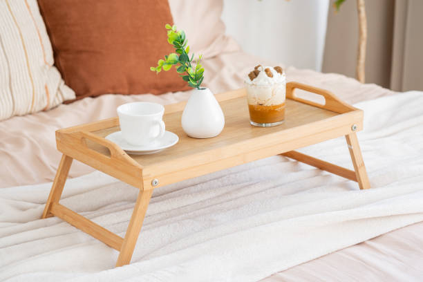 istock Cozy breakfast tray with coffee and dessert on soft bedding in a sunny room 2195875807