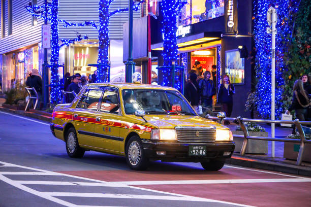 Tokyo, Japan - January 14, 2025: Yellow taxi car Toyota Comfort (XS10) in the city street.
