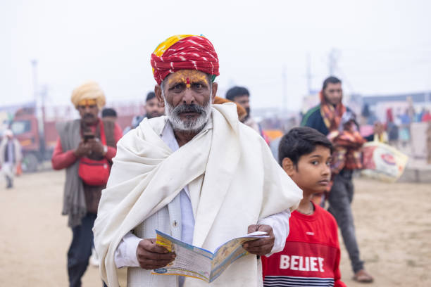 Prayagraj, Uttar Pradesh, India - January 2025: Mahakumbh, Portrait of holy male sadhu baba participating in maha kumbh mela at prayagraj during the foggy morning to take the holy dip in river ganga.