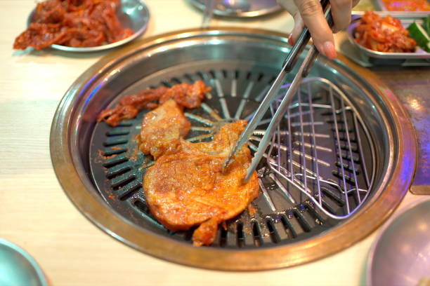 istock Asian woman eating Korean BBQ. 2195885109