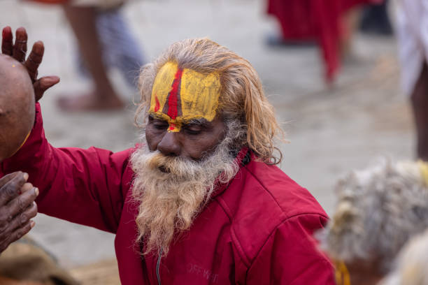 Prayagraj, Uttar Pradesh, India - January 2025: Mahakumbh, Portrait of holy male sadhu baba participating in maha kumbh mela at prayagraj during the foggy morning to take the holy dip in river ganga.