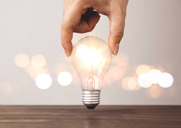 istock Hand holding a light bulb with bright light. Concepts of creative innovation, new ideas 2195887144