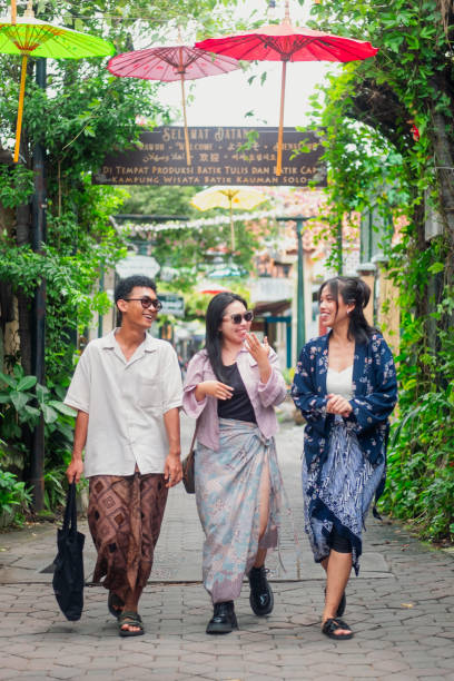 istock Three Friends Strolling Through the Batik Village in Style 2195887857
