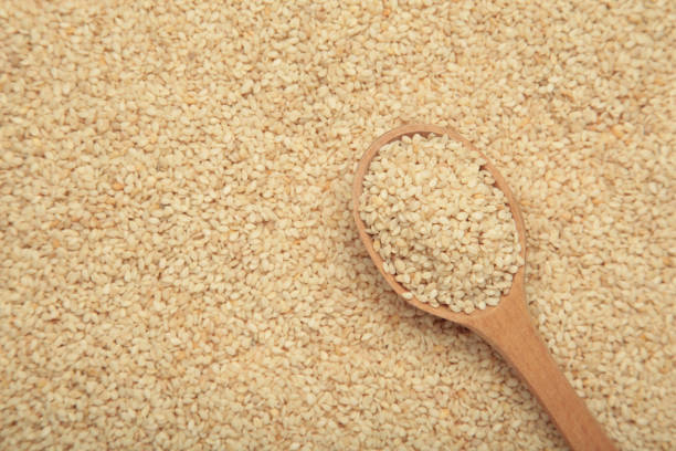 istock Organic White Sesame seeds on wooden spoon. 2195891206