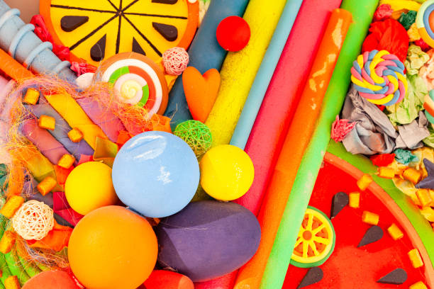 istock Various plastic decorative ornaments collected in a pile, close-up. 2195899004