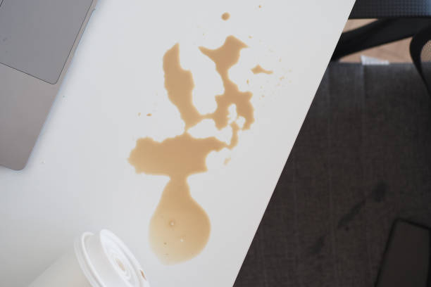 istock A drink was accidentally spilled on a desk with a laptop and glasses, creating a mess 2195899321