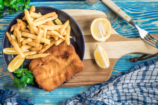 istock A piece of fried cod with fries on a plate. 2195900425