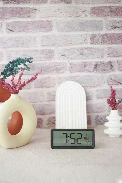 istock A Vibrant Decorative Arrangement Featuring a Modern Clock Surrounded by Lush Plants 2195901670