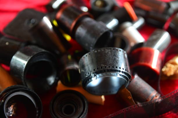 Negative 35mm film rolls and cassettes isolated on red